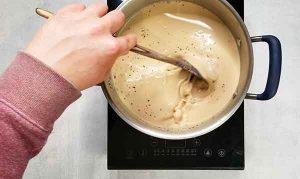 stirring the dairy free baileys on the stove
