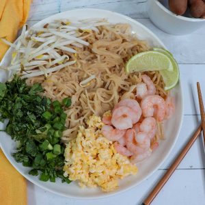 gluten free pad thai on plate with chop sticks