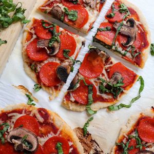 picture of finished pizzas topped with fresh basil