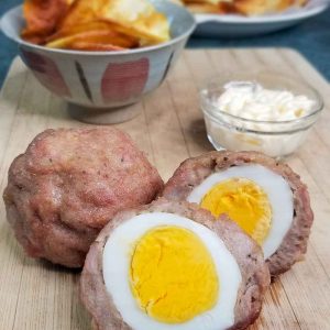 Picture of paleo scotch egg with homemade potato chips and mayonnaise for dip