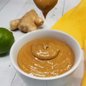 picture of pouring nut free thai peanut sauce into bowl