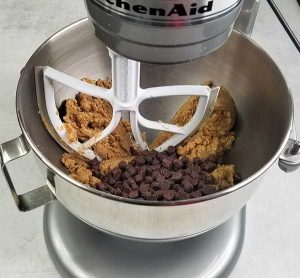 chocolate chips in bowl with dough ready to be mixed