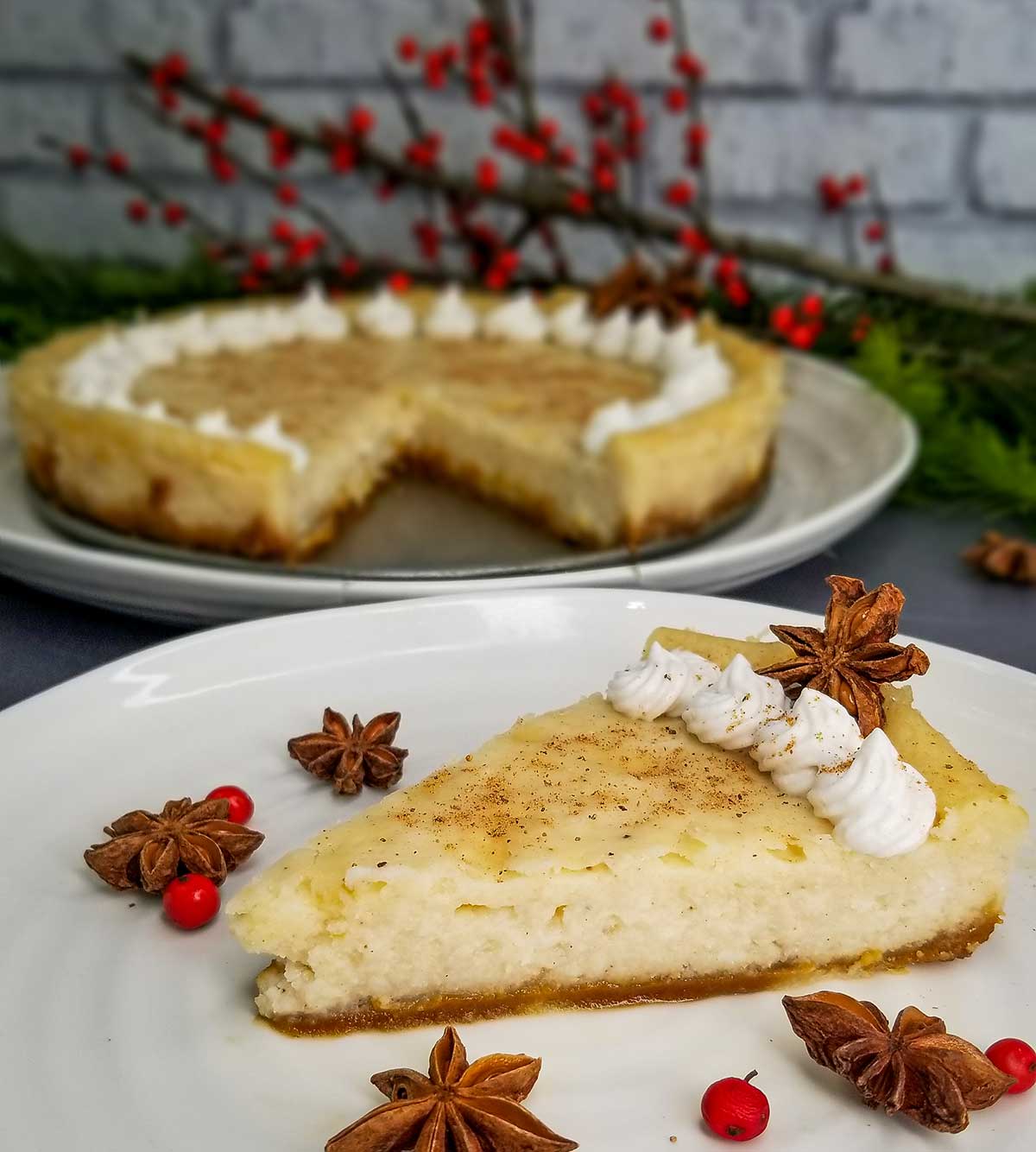 one piece of eggnog cheesecake with the rest of the cheesecake behind