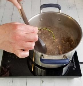 fishing out time sprigs from pot