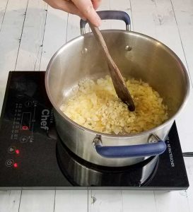 sautéing onions in pot on stove