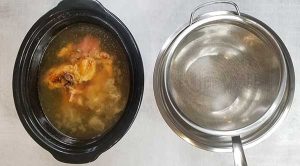 slow cooker with bones and broth ready to be strained into large bowl