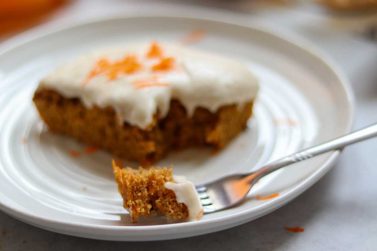 carrot cake slice with fork on plate