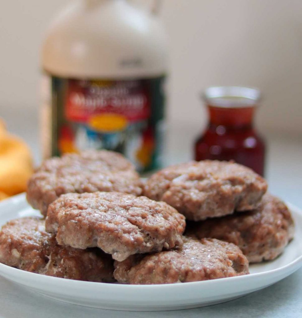 Maple breakfast sausage recipe oven baked on plate with syrup