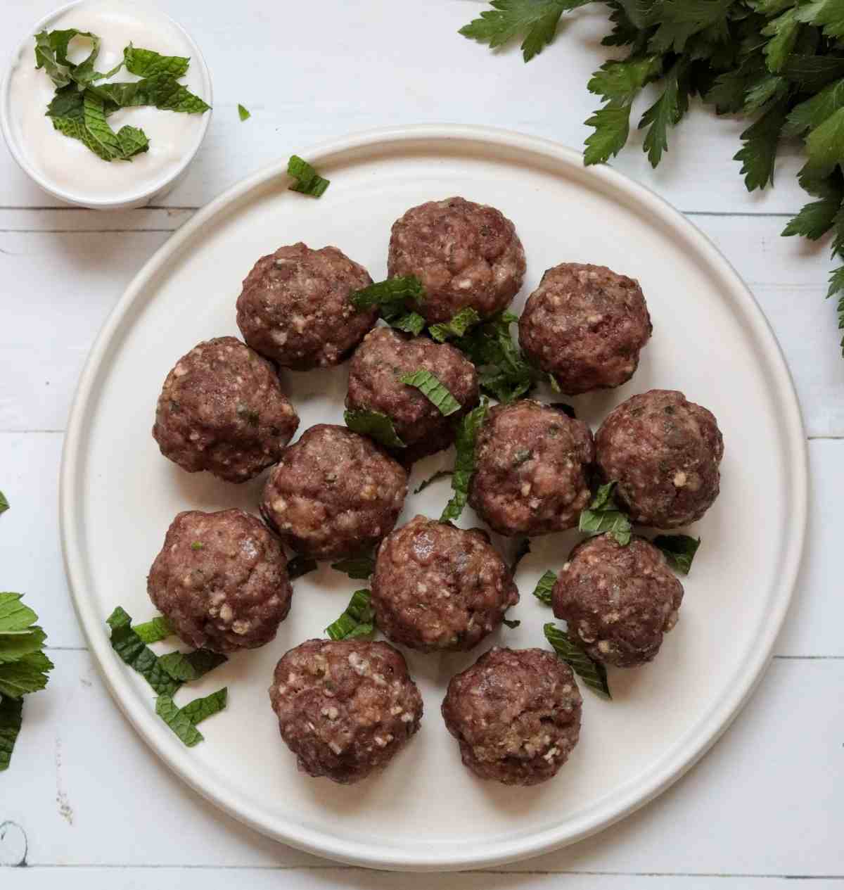 baked greek meatballs on a white plate