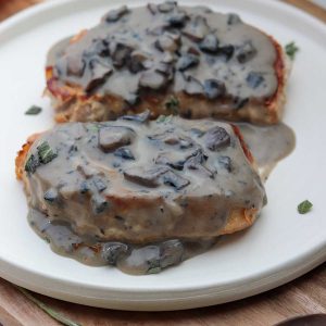 Close-up of pork chops with mushroom sauce on plate