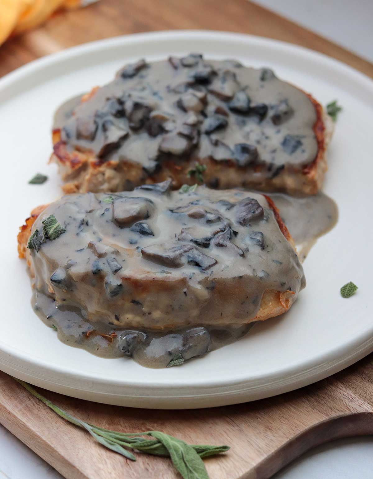 Close-up of pork chops with mushroom sauce on plate