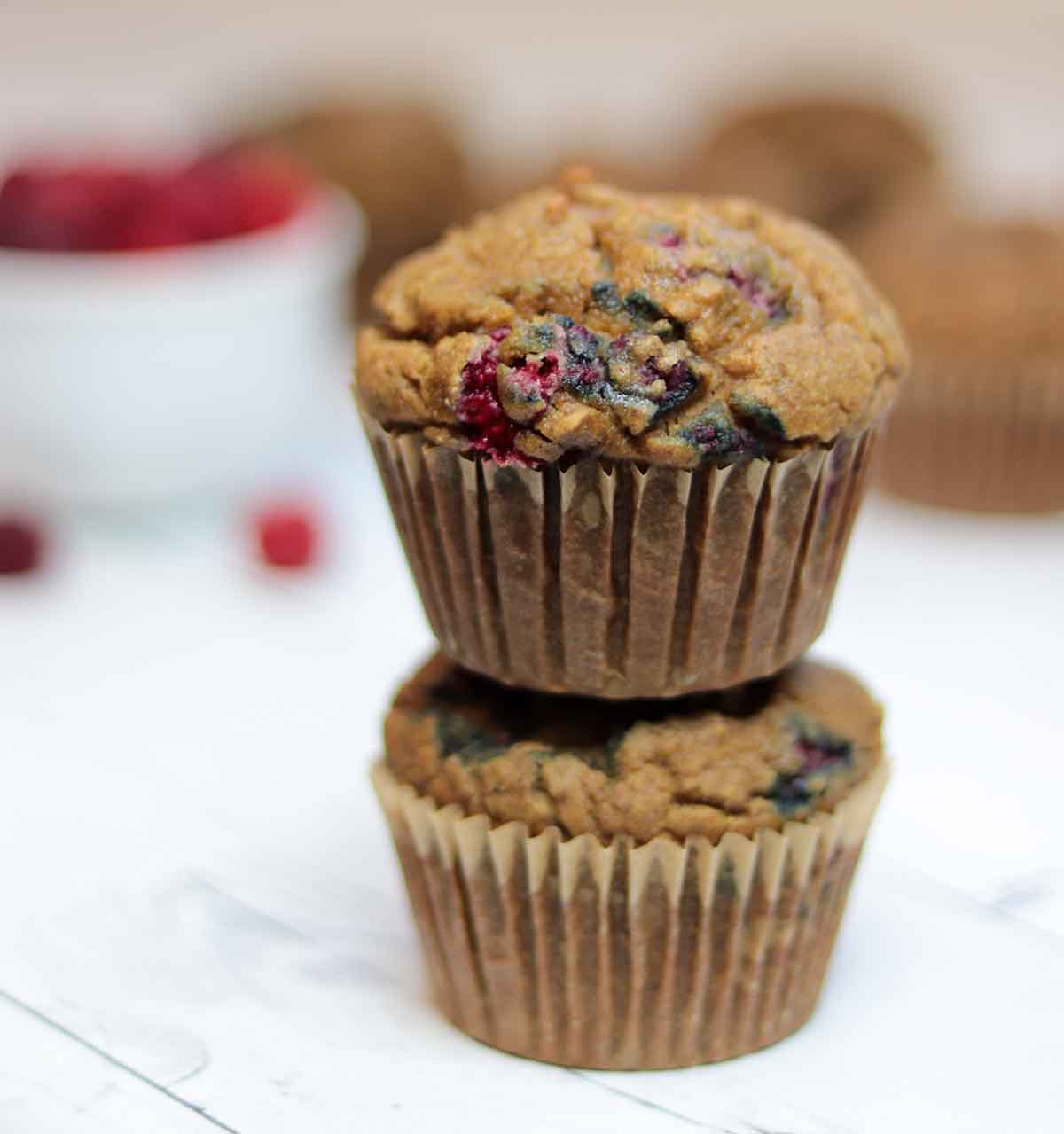 2 raspberry muffins stacked on top of each other