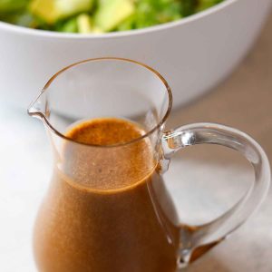 Creamy balsamic dressing in small glass pitcher