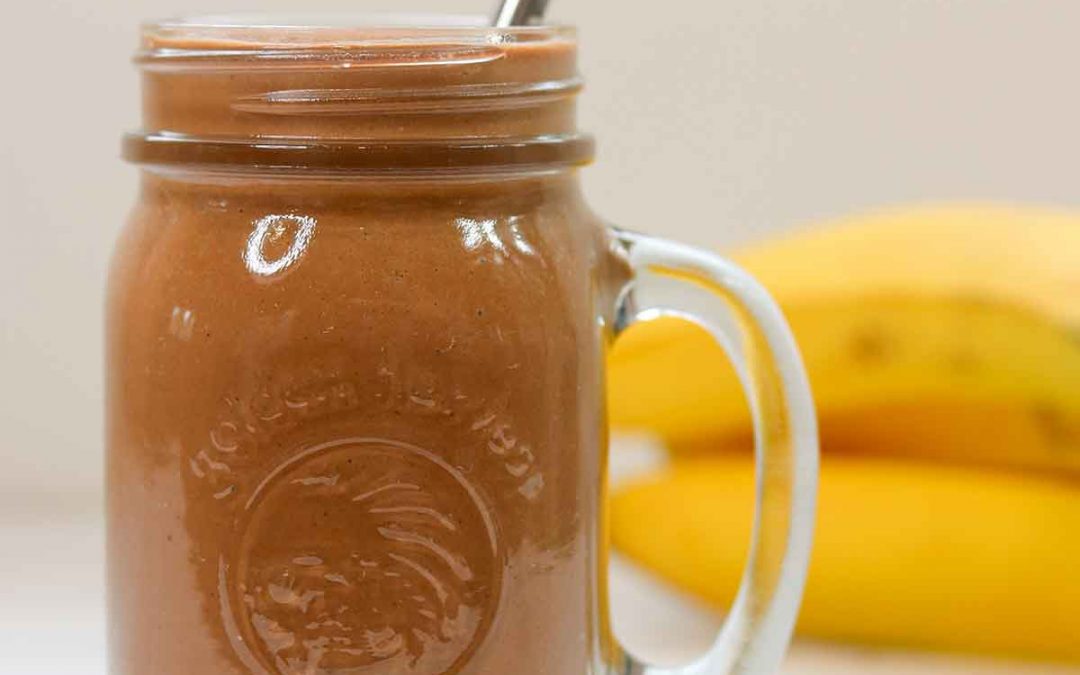 Chocolate peanut butter smoothie in mason jar ready to drink