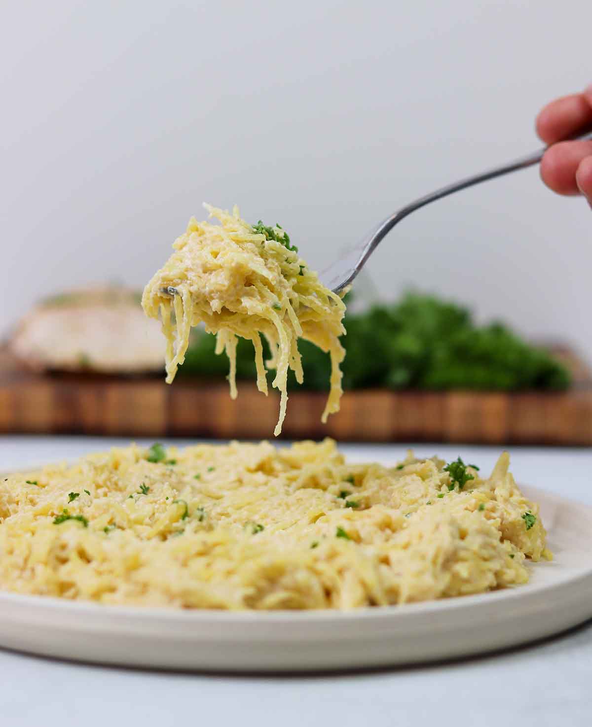 Picture of bite of chicken alfredo on fork