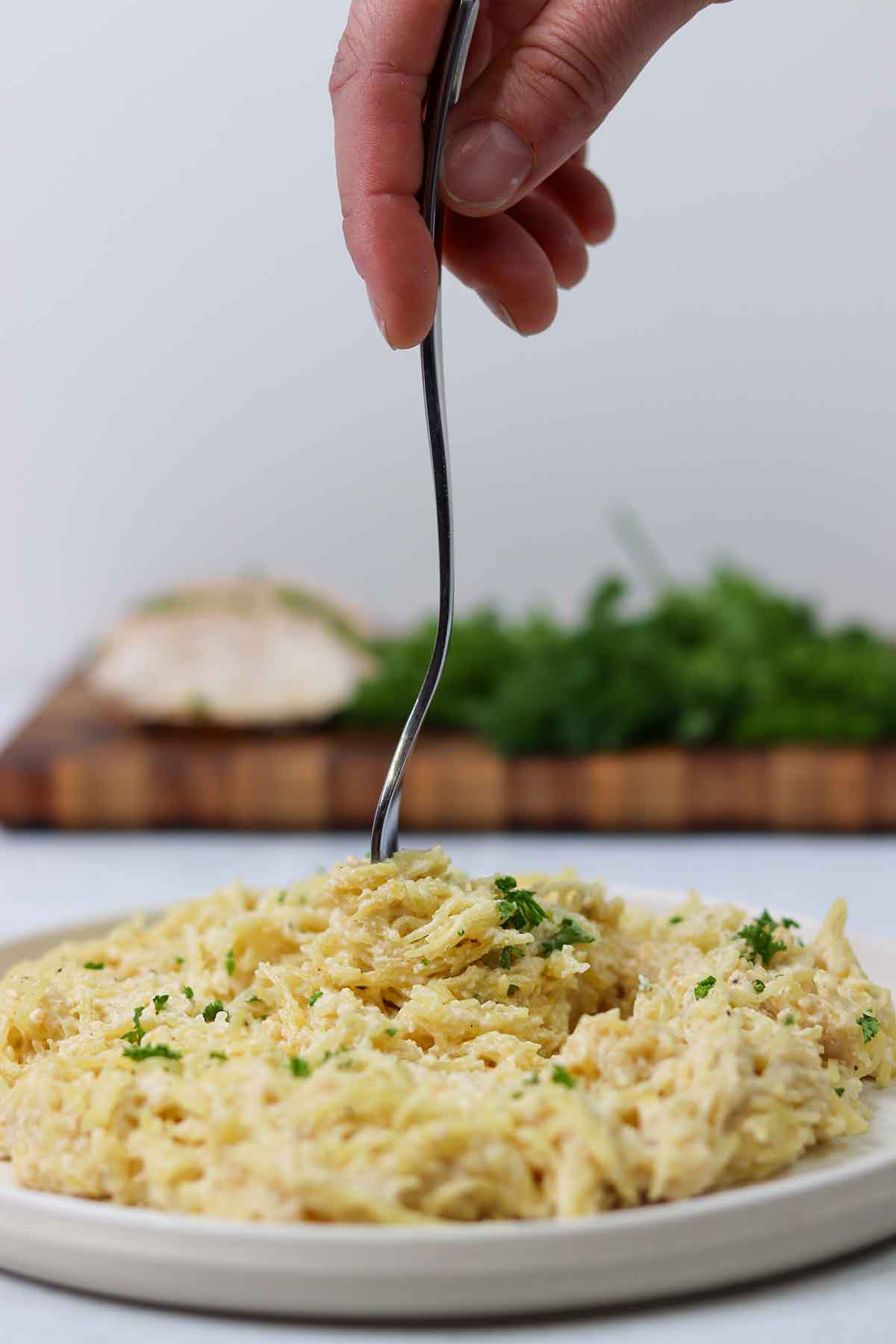 Picture of keto chicken alfredo being stirred with fork from above.