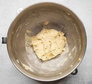 Ball of dough after scraping down the sides of the stand mixer bowl with a spatula