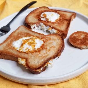 Scotch eggs with cutout toast sitting on plate ready to be eaten