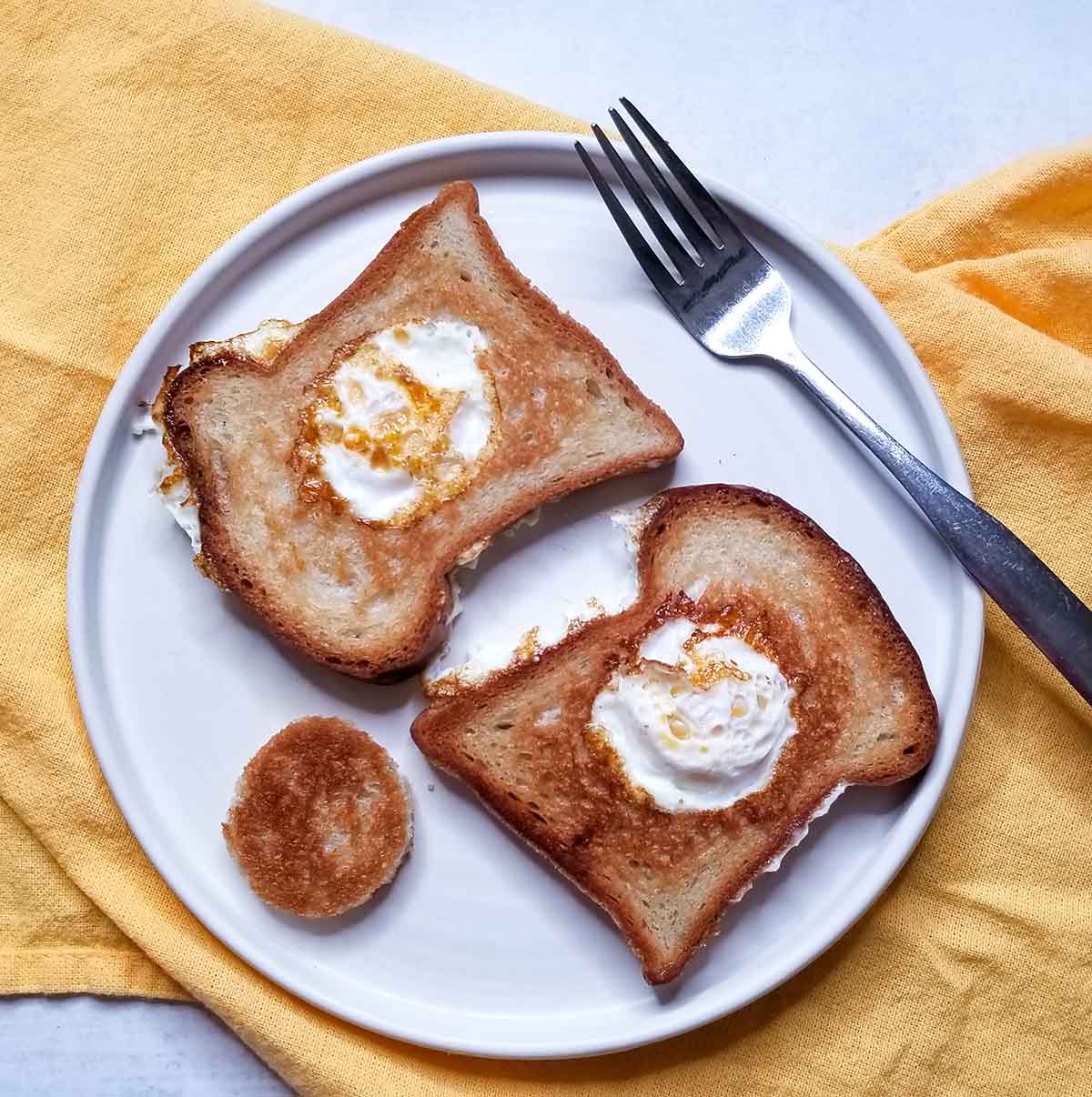 Scotch eggs with a breakfast patty on a white plate 