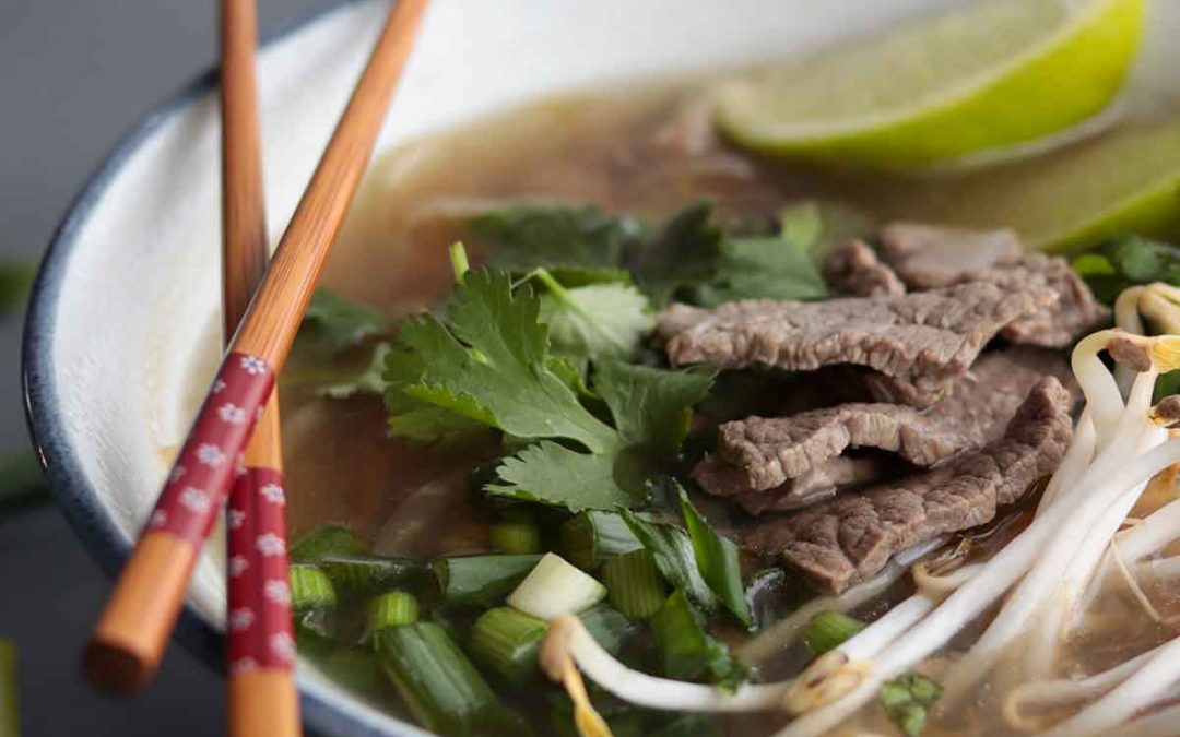 Keto Pho in blue ceramic bowl with chopsticks crossed and balanced on the sideKeto pho soup recipe (easy & fast) This keto pho soup recipe is fast and easy to make because it uses store-bought pho broth and pre-spiralized kohlrabi noodles. Below I also provide options for making your own broth, as well as other low carb noodle alternatives. Recipes substitutions and variations (H2) Store-bought pho broth substitutions: To make this recipe super quick and easy, I made use of premade pho broth from the store. However, if you want to keep the ingredients super clean you can also use your own homemade bone broth and then add pho seasonings to it. This could include star anise, cloves, cinnamon, cardamom, and coriander. You can also add lime, onion, ginger, salt and fish sauce. Beef rouladen substitutions: Traditional pho recipes are generally made with thinly sliced beef. To make things easier, I bought pre sliced beef rouladen. This is essentially long, thin strips of beef that are super easy to slice up into smaller pieces. You can also use any other cut of beef and slice it up as thinly as possible using a meat slicer or sharp knife. I have also made this soup with thinly sliced “hot pot” pork shoulder or chicken and it’s also fantastic. I found these in the frozen meat section of the grocery store. Kohlrabi noodle substitutions: For this recipe, I highly recommend using Mann's Kohlrabi “Linguine” which I get at my local Save-On-Foods. If you aren’t able to access this, you can also spiralize your own kohlrabi noodles with a vegetable spiralizer. Or you can find other spiralized vegetables to use instead as your noodle base such as sweet potatoes, zucchini, or butternut squash. Or if you are not concerned about making this lower in carbohydrates, you can of course use regular rice noodles. Shallot substitutions: Instead of using shallots, you can also swap it out for regular white onion. Or even dehydrated onion flakes. Fresh herb substitutions: Instead of using fresh basil and cilantro, you can swap it out for dried basil and cilantro. If you do this though, add them to your pot at the same time you add your noodles, instead of at the end. This will help infuse the broth with the herbs flavour. Just keep in mind you will not get the fresh, intense flavour of the fresh herbs if you do this. The fresh herbs also provide a really beautiful presentation to your dish. Green onion substitutions: Instead of green onions, you can also swap it out for fresh chives. If you aren't able to get fresh, you can use dehydrated chives. If you do this, add your chives at the same time you add your noodles. This will allow the dehydrated chives to rehydrate and infuse their flavour into the broth. Lime substitutions: The lime is used for garnish and flavour at the end. If you don't have fresh lime, you can also use store-bought lime juice. Dietary modifications for this recipe (H2) Make this recipe low FODMAP: Omit the shallot and make sure your broth does not contain garlic or onion, or any other high FODMAP vegetable. Make this recipe AIP: Avoid store-bought broth. Use your own bone broth and then add in AIP friendly ingredients such as ginger, fish sauce, garlic, onion, and cinnamon. Make this recipe candida diet friendly: Avoid broth that contains sugar or yeast. Or alternatively, make your own broth using bone broth and add seasonings such as star anise, cloves, cinnamon, cardamom, coriander, lime, ginger and salt. Make this recipe even lower carb: Store-bought pho broth isn't super high in carbohydrates, although the stuff I used does add about 5 g of carbohydrates per serving of this soup. To make this recipe even lower in carbs, use your own homemade pho broth. Pro tips for this recipe: (H2) Add your fresh herbs, bean sprouts and green onions at the end Adding your herbs and garnishes at the end will make for a beautiful presentation and gives the soup a fresher, crunchier texture. Don’t cook the meat for too long In this recipe, I call for adding the meat at the very end. Because the meat is so thinly sliced, you don’t want to overcook it and have it be chewy and not as tender. The meat cooks really fast so it only needs a few minutes to cook through. Frequently asked questions: (H2) How long does this soup last in the fridge? This soup will last in the fridge for up to 1 week but I recommend eating it up within a few days for ultimate freshness. This soup freezes very well, so if you aren’t able to finish it up, portion it out and freeze it in glass containers. Does this low carb pho freeze well? This soup freezes incredibly well, even with the fresh herbs and garnishes on top. I make this soup for weekly meal prep and portion it out and freeze it. Then I take it out the night before I plan to eat it for lunch. Pin this recipe for later (H2) If you can’t make my homemade pho soup now, make sure to pin the recipe for later so you have it handy! > Tried my easy homemade pho? (H2) Please leave me a rating and review below, and post a picture of the dish to Instagram and tag me at @foodsnfeels 🙌 You might also like: (H2) If you liked my healthy pho recipe, check out my other soup recipes: Keto chicken bacon soup How to make bone broth in a crock pot Cream of mushroom soup Moose stew slow cooker Ham bone split pea soup