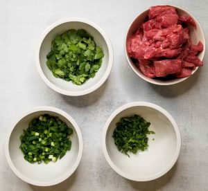 Pho ingredients in small white bowls