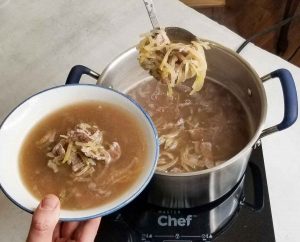 Keto pho being served out of large silver pot