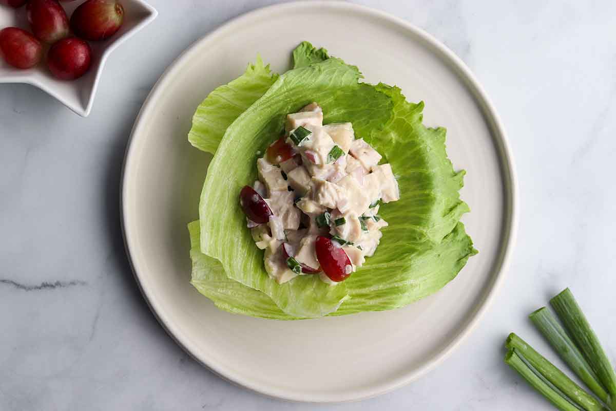 Overhead view of chicken salad on white plate