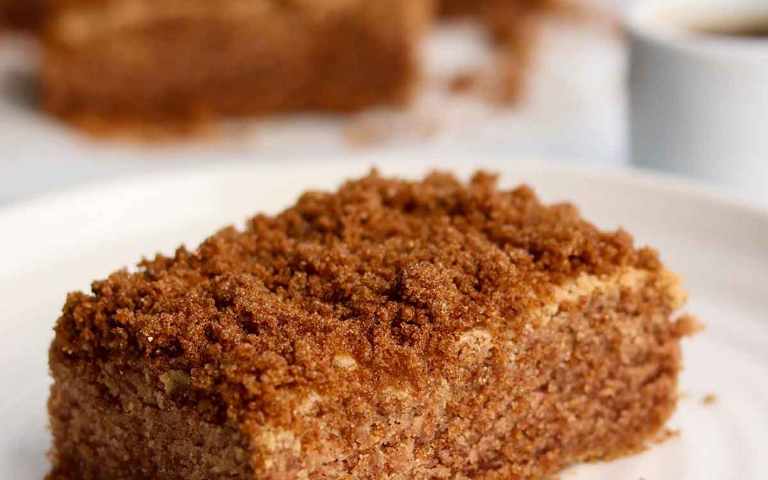 zoomed in view of coffee cake sitting on a white plate