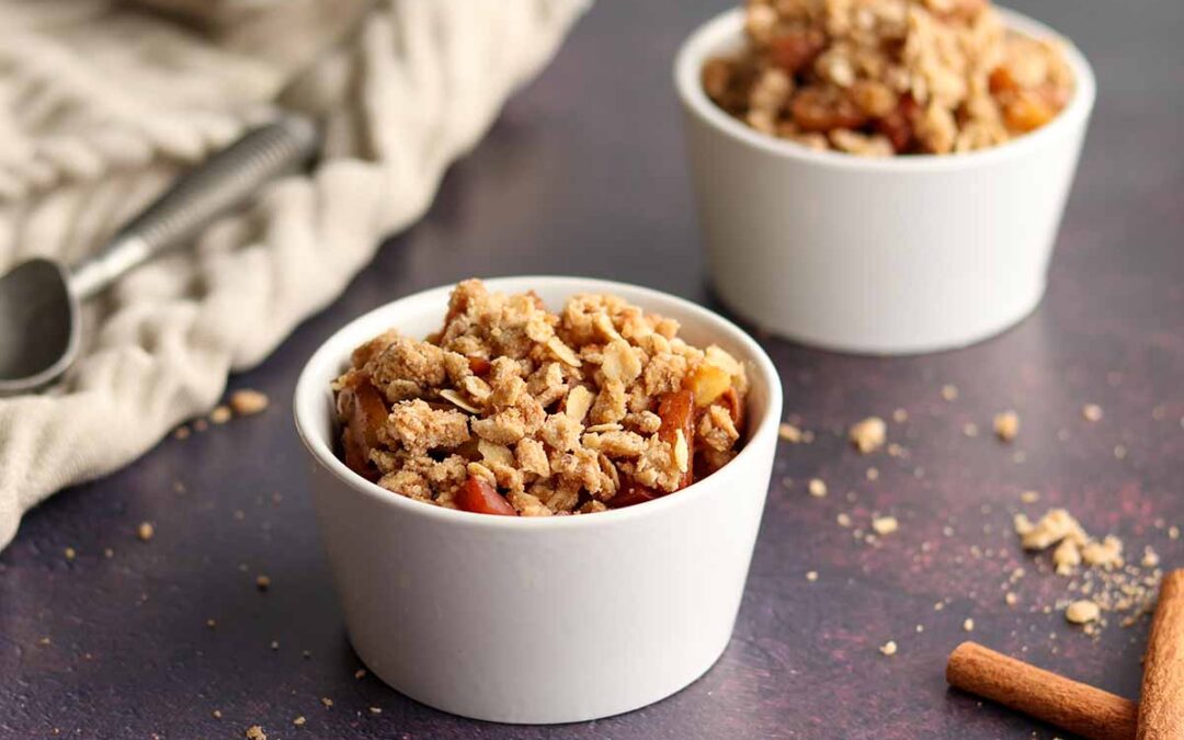 2 servings of apple crisp in small white ramekins