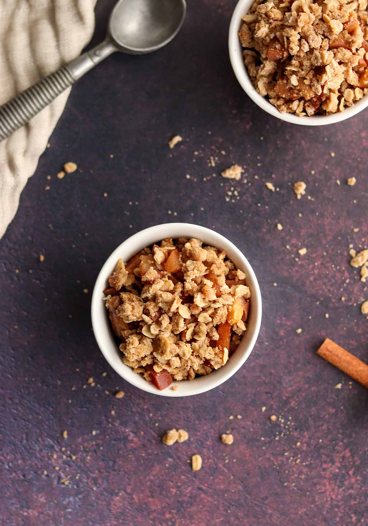 overhead shot of 2 servings of apple crisp in white ramekins