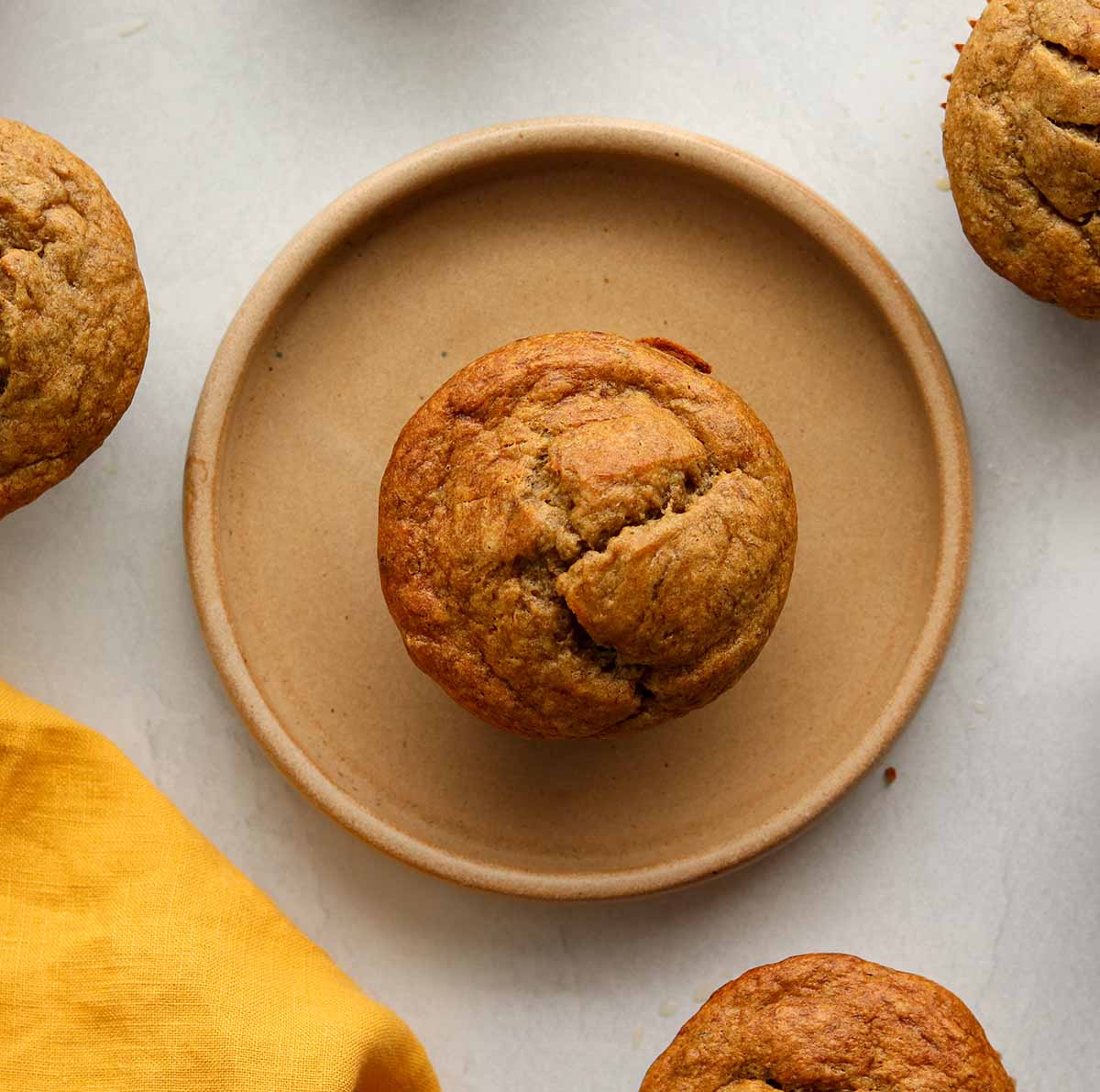 Overhead view of muffin on a modern brown ceramic plate