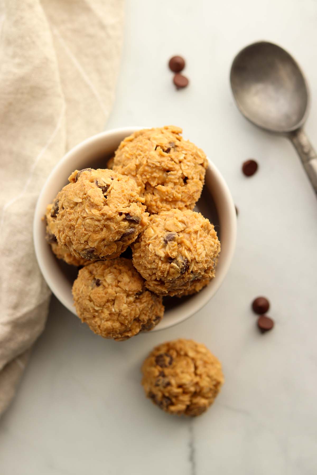 Overhead view of edible cookie dough scooped into balls and placed in a dish.