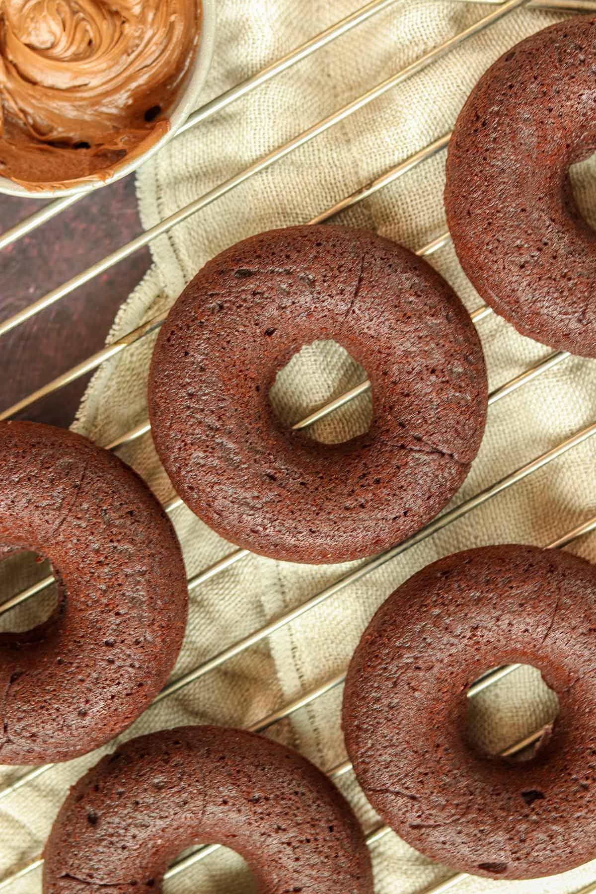 Overhead view of chocolate cassava flour donuts on cooling rack