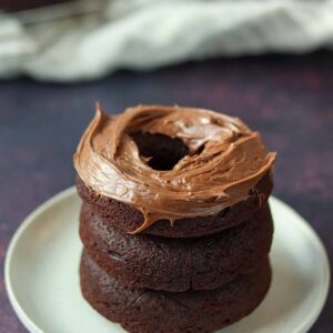 Stacked chocolate cassava flour donuts with chocolate icing.
